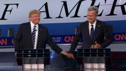 Donald Trump and Jeb Bush high-five after Bush's answer that his Secret Service codename would be Everready.