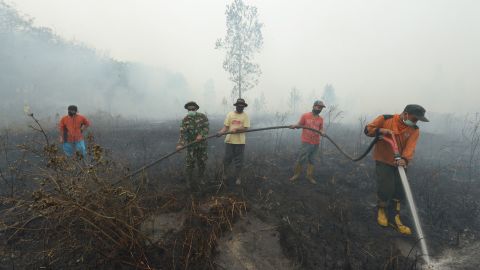 Firefighters work in Kampar on Sunday, September 13. 