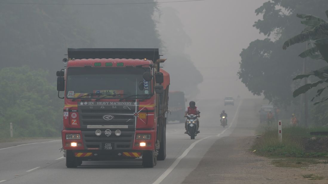 Motorists drive on a street in Karak, Malaysia, on September 15.