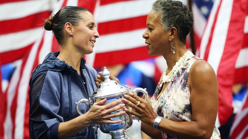 NEW YORK, NY - SEPTEMBER 12:  USTA Chairman, CEO and president Katrina Adams (R) presents the winner's trophy to Flavia Pennetta of Italy after she defeated Roberta Vinci of Italy during their Women's Singles Final match on Day Thirteen of the 2015 US Open at the USTA Billie Jean King National Tennis Center on September 12, 2015 in the Flushing neighborhood of the Queens borough of New York City. Pennetta defeated Vinci 7-6, 6-2.  (Photo by Matthew Stockman/Getty Images)