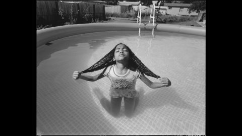 Tiny's daughter Kayteonna kneels in a pool in 2014.