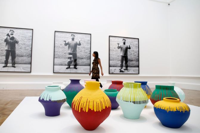 Back: <em>Dropping a Han Dynasty Urn</em>, 1995. Front: <em>Coloured Vases</em>, 2006<br />Neolithic vases (5000-3000 BC) painted by the artist with industrial paint. Ai's destruction or appropriation of ancient Chinese urns have been seen as provocative comments on the vandalism of ancient Chinese culture by the country's modern leaders. 