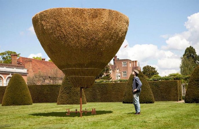 "In 2012 I inverted a thatched roof for a rural commission titled <em>Under the thumb to hide from the fingers</em>. The roof seemingly stood on its weathervane and slowly turned in the wind." 