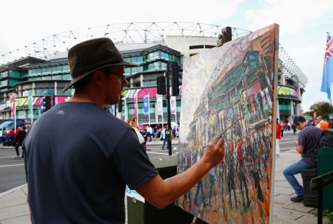 An artist paints outside Twickenham ahead of England's game against Fiji.