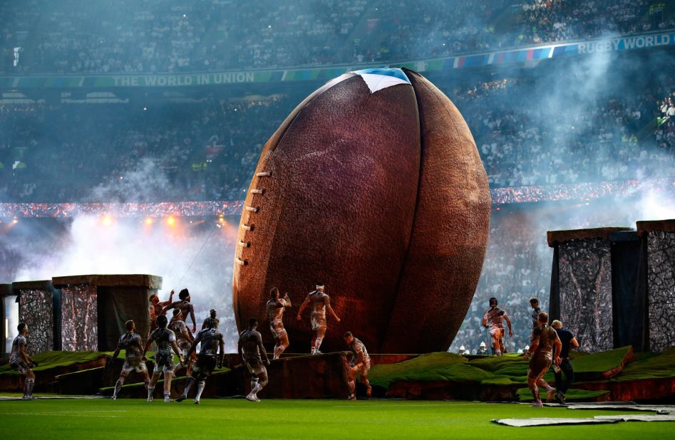 A giant rugby ball dominates the center of the field during the opening ceremony.
