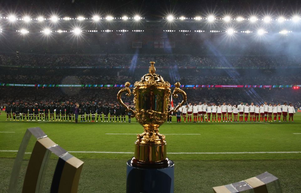 The two teams line up for the national anthems behind the Webb Ellis Cup, the prize for the world champions.