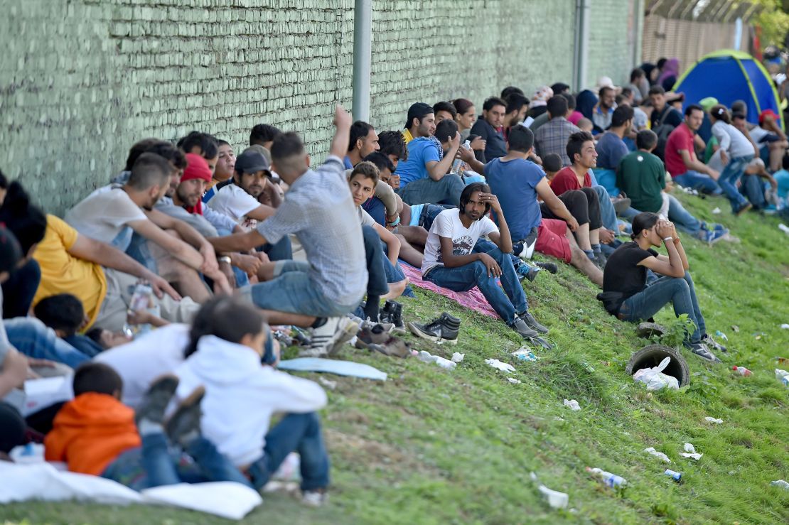 Migrants wait in Tovarnik, Croatia, for transport north on Saturday.