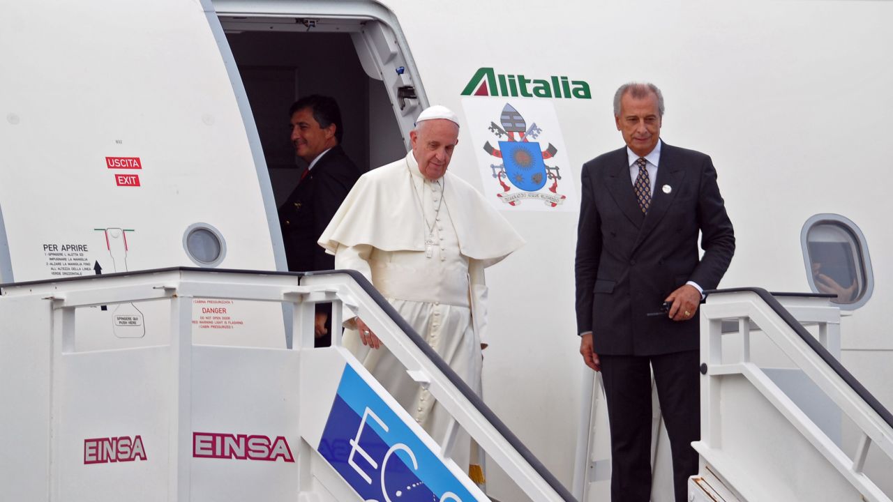 Pope Francis (C) exits his plate upon landing at Havana's international airport on September 19, 2015, on the first leg of a high-profile trip that will also take him to the United States. AFP PHOTO / Yamil Lage        (Photo credit should read YAMIL LAGE/AFP/Getty Images)