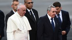 Pope Francis (C-L) is welcomed by Cuban President Raul Castro (C-R) upon landing at Havana's international airport on September 19, 2015 on the first leg of a high-profile trip that will also take him to the United States. AFP PHOTO / FILIPPO  MONTEFORTE        (Photo credit should read FILIPPO MONTEFORTE/AFP/Getty Images)