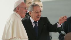 Pope Francis speaks with Cuba's President Raul Castro during his arrival ceremony at the airport in Havana, Cuba, Saturday, Sept. 19, 2015. Pope Francis begins a 10-day trip to Cuba and the United States on Saturday, embarking on his first trip to the onetime Cold War foes after helping to nudge forward their historic rapprochement. (AP Photo/Ramon Espinosa)