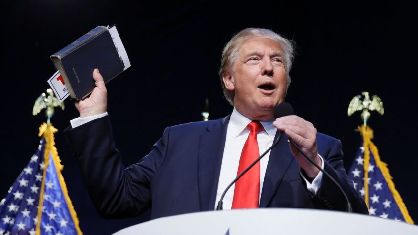 Republican presidential candidate, businessman Donald Trump holds a Bible as he speaks during the Iowa Faith & Freedom Coalition's annual fall dinner, Saturday, Sept. 19, 2015, in Des Moines, Iowa. (AP Photo/Charlie Neibergall)