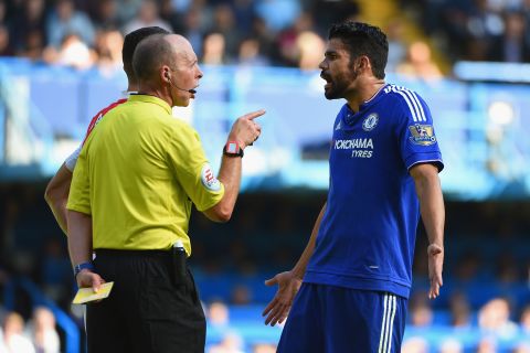 Costa is shown a yellow card by referee Mike Dean, who sent off Paulista for retaliating against the Spain striker.