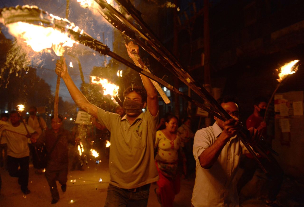 Nepalese activists from marginalized Tharu community take part in a torch rally against the division of Tharu-majority districts in the country's proposed federal structure in Kathmandu on August 11, 2015. 