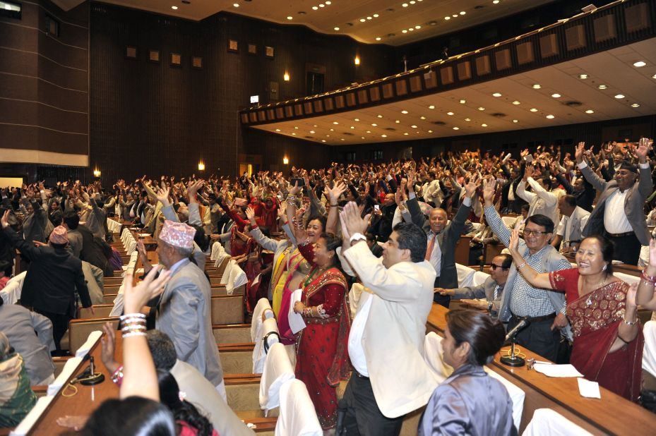 Nepalese lawmakers wave while Nepal's parliament passes a new national constitution in Kathmandu on September 16, 2015.