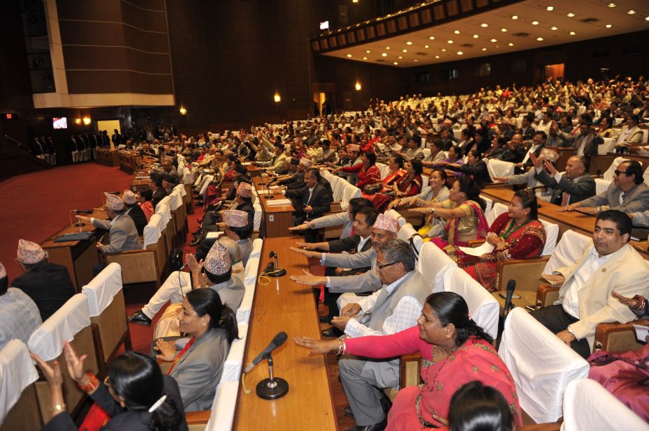 Nepalese lawmakers clap while Nepal's parliament passes a new national constitution in Kathmandu on September 16, 2015.