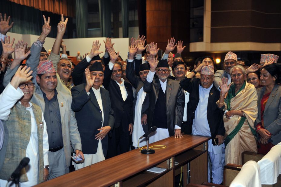 Nepalese Prime Minister Sushil Koirala, Unified Marxist Leninist chairman K P Oli, Nepalese Unified Communist Party of Nepal (Maoist) chairman Pushpa Kamal Dahal, known better as Prachanda and other lawmakers wave while Nepal's parliament passes a new national constitution in Kathmandu on September 16, 2015.