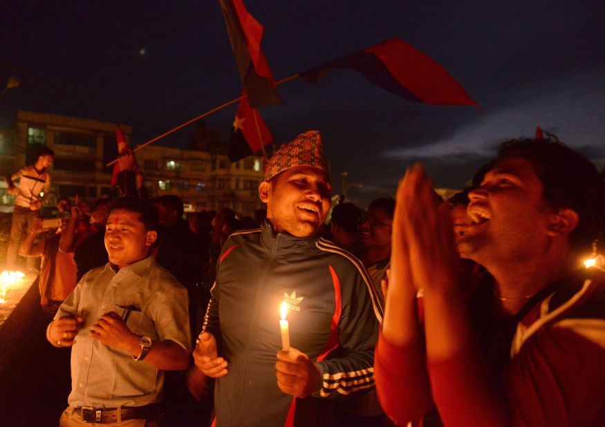 In this photograph taken on September 17, 2015, Nepalese activists hold lighted candles as they celebrate the country's new national constitution in Kathmandu. 
