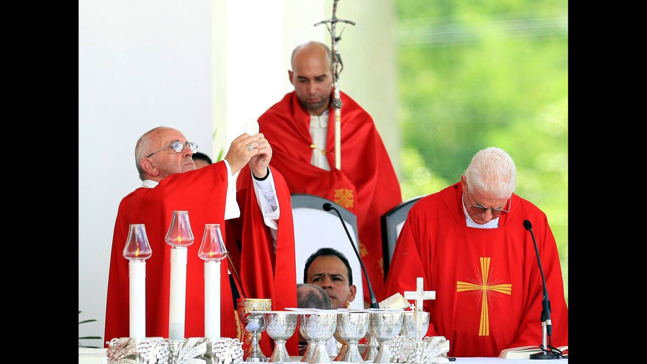 Pope Francis, left, blesses the communion bread during the Holguin Mass on September 21.