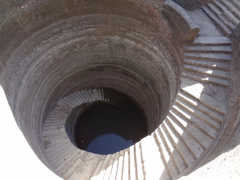 "When I give lectures, the so-called Helical vav invariably causes gasps -- something about that sinuous spiral and severe simplicity is so compelling. Even more startling -- as with many stepwells -- is the subtlety of it's above-ground presence: just a low masonry wall. Lovely."<br />