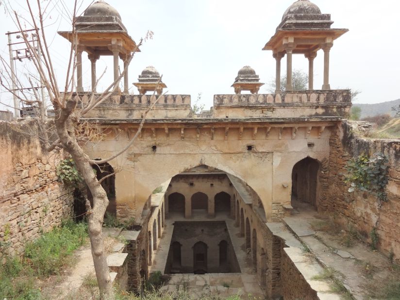 "It's not easy getting to this small stepwell in the fields outside the city of Narnaul, with its many spectacular Mughal monuments. But the dirt road eventually lead to pretty -- if overgrown -- stepwells, with its four chattris that come into view. What a peaceful spot in its day - I'm sorry this one's such a ruin."