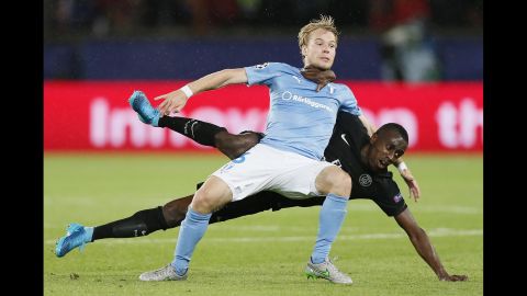 Malmo's Oscar Lewicki, foreground, jostles with PSG's Blaise Matuidi during a Champions League soccer match in Paris on Tuesday, September 15.