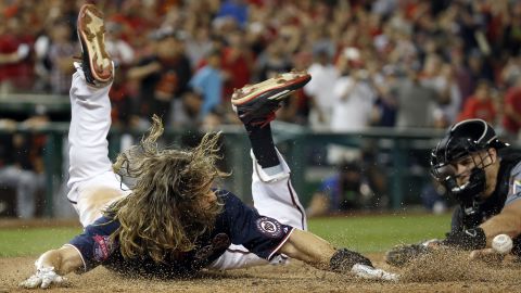 Washington Nationals outfielder Jayson Werth slides into home plate to score the winning run Friday, September 18, against Miami. The run was scored in the 10th inning after a sacrifice fly by Jose Lobaton.