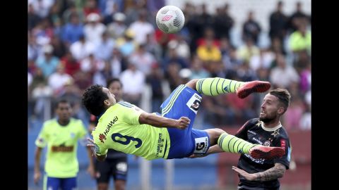 Sporting Cristal's Cesar Pereyra goes horizontal as he tries to kick a ball Wednesday, September 16, in Cajamarca, Peru.