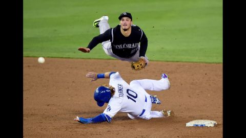 Colorado's Nolan Arenado goes airborne as he turns a double play in Los Angeles on Tuesday, September 15.
