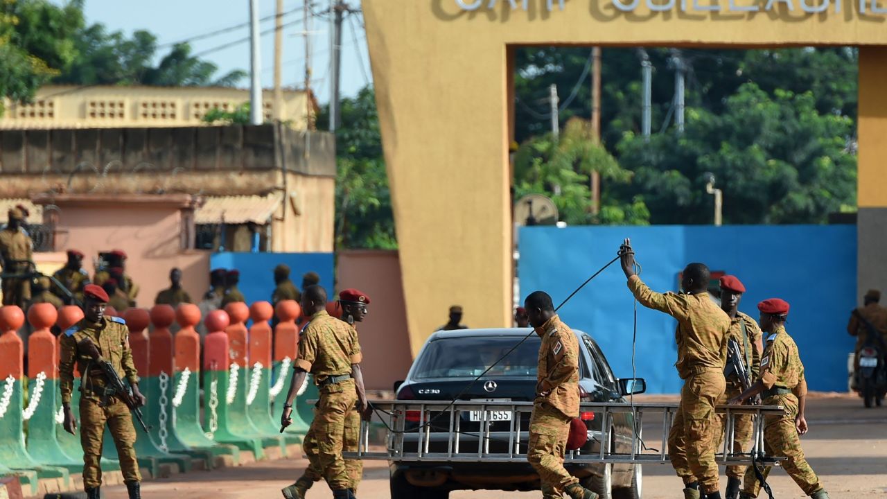 Burkina Faso army troops stand guard outside Guillaume Ouedraogo military camp in Ouagadougou on Tuesday, September 22, 2015.
