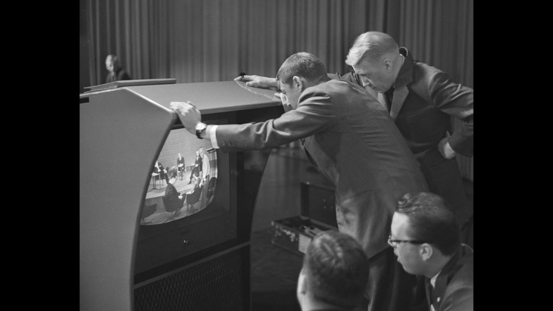 Stanton, right, and producer Don Hewitt check a television monitor before the debate.