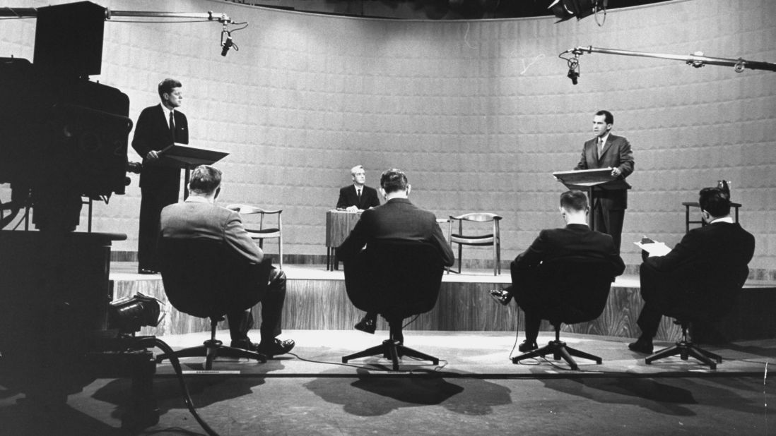 The debate started with eight-minute opening statements and then moved on to alternating questions from panelists, seen here in the foreground.