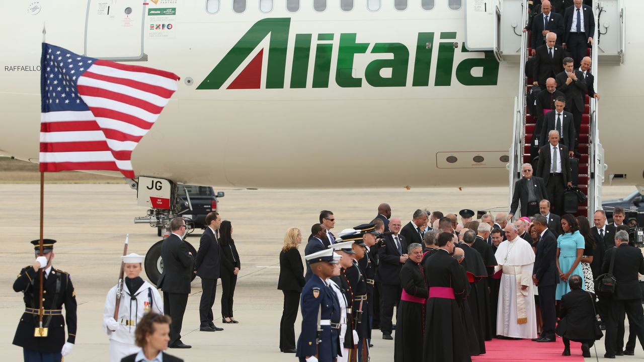 Pope Francis shakes hands with Vice President Joe Biden along with U.S. President Barack Obama, first lady Michelle Obama, and other political and Catholic church leaders after arriving from Cuba September 22, 2015 at Joint Base Andrews, Maryland. 