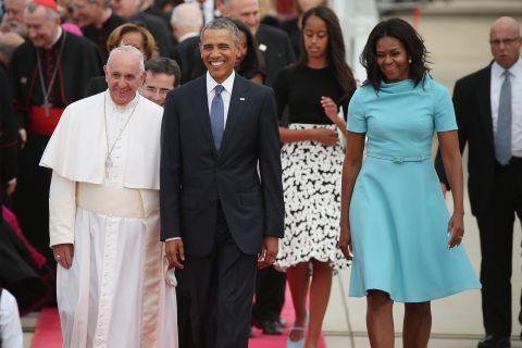 Pope Francis is escorted by the Obamas and their daughters after arriving in the country.