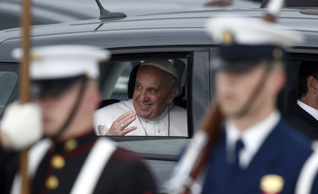 Pope Francis waves from his car at Andrews Air Force Base.