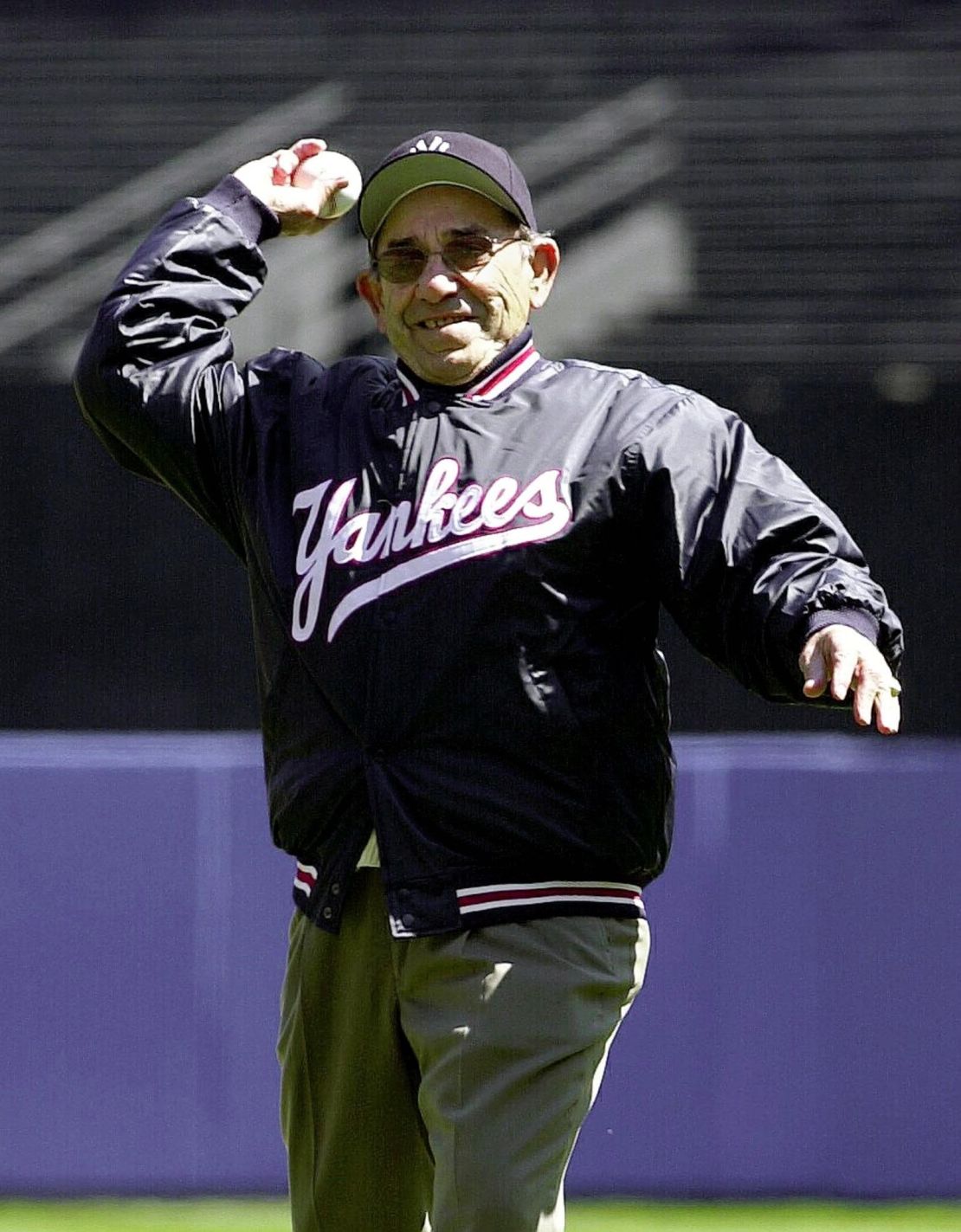 The retired legendary catcher throws out the first pitch to start the Yankees' home season in April 2000. 