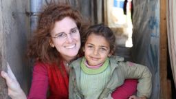 Barbara Massaad poses with a refugee child at the Hamra Street refugee camp in Beirut. Her experience at this camp inspired her to create the humanitarian cookbook "Soup for Syria".