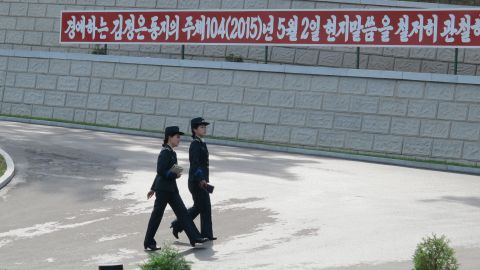 Two officials walk across the facility. Kim Gun Song (not pictured), who is in charge of the satellite control center, said they "believe the threat to world security does not come from the peaceful launches of satellites from North Korea, but...from other countries who are trying to use outer space for military purposes."