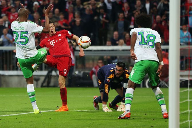 VfL Wolfsburg's Naldo, Dante and goalkeeper Diego Benaglio are powerless to prevent Lewandowski scoring his third goal threes minutes later. By this point he had been on the pitch for nine minutes, breaking another Bundesliga record.