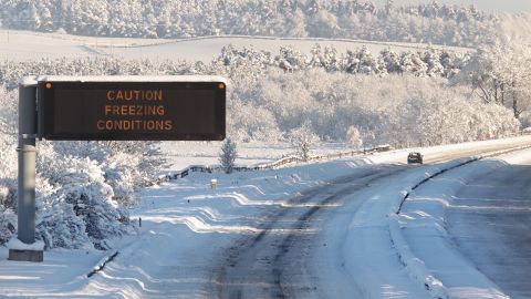 A solitary car makes its way along the snowbound M8 motorway linking Glasgow and Edinburgh