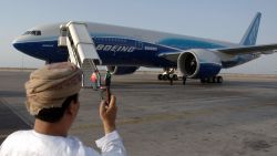 MUSCAT, OMAN:  An Omani man takes a picture with his mobile phone of the Boeing777 worldliner which touched down in Muscat 22 June 2005, after having been on display at the 46th International Paris Air Show at Le Bourget airport as part of its global test flight which began in Montreal, Canada on June 08. The worldliner's "Going the Distance" tour will visit more than 20 cities in the Middle East, Asia, Europe, Australia and north America over an eight-week period. AFP PHOTO/MOHAMMED MAHJOUB  (Photo credit should read MOHAMMED MAHJOUB/AFP/Getty Images)