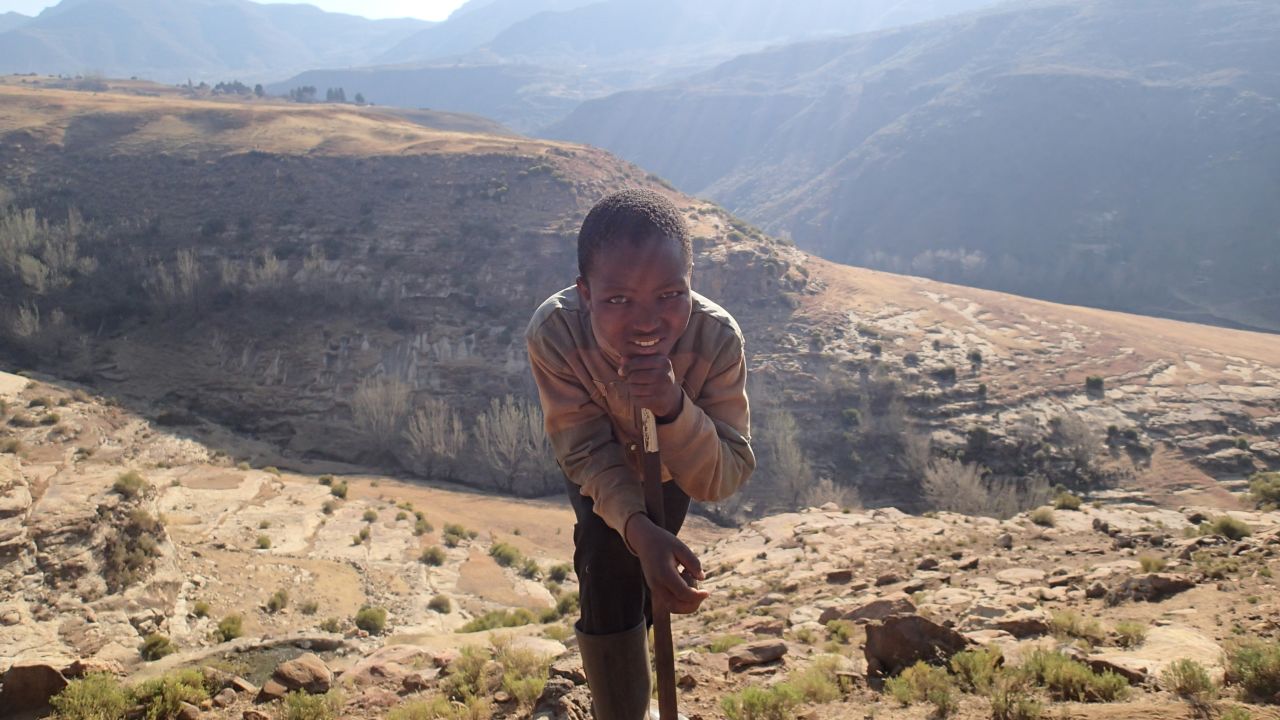 Rutland had lived in Asia and Europe but never seen much of his own continent. Pictured, a boy poses for Rutland's camera in one of Lesotho's mountains.