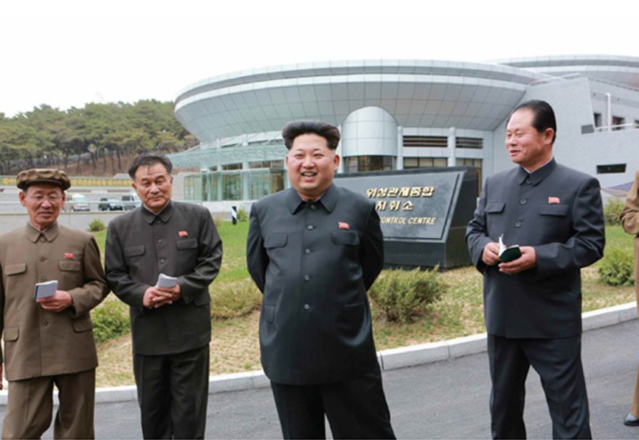 Kim Jong Un, the supreme leader of North Korea, poses in front the satellite control center during an undated visit believed to be earlier this year.