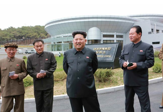 Kim Jong Un, the supreme leader of North Korea, poses in front the satellite control center during an undated visit believed to be earlier this year.