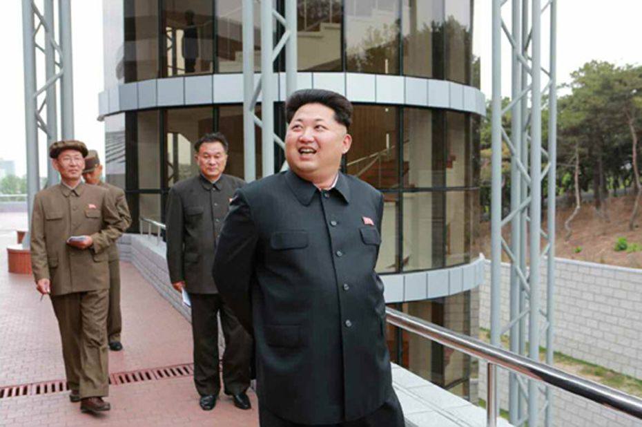 Kim Jong Un is pictured smiling during his visit to the satellite control center.