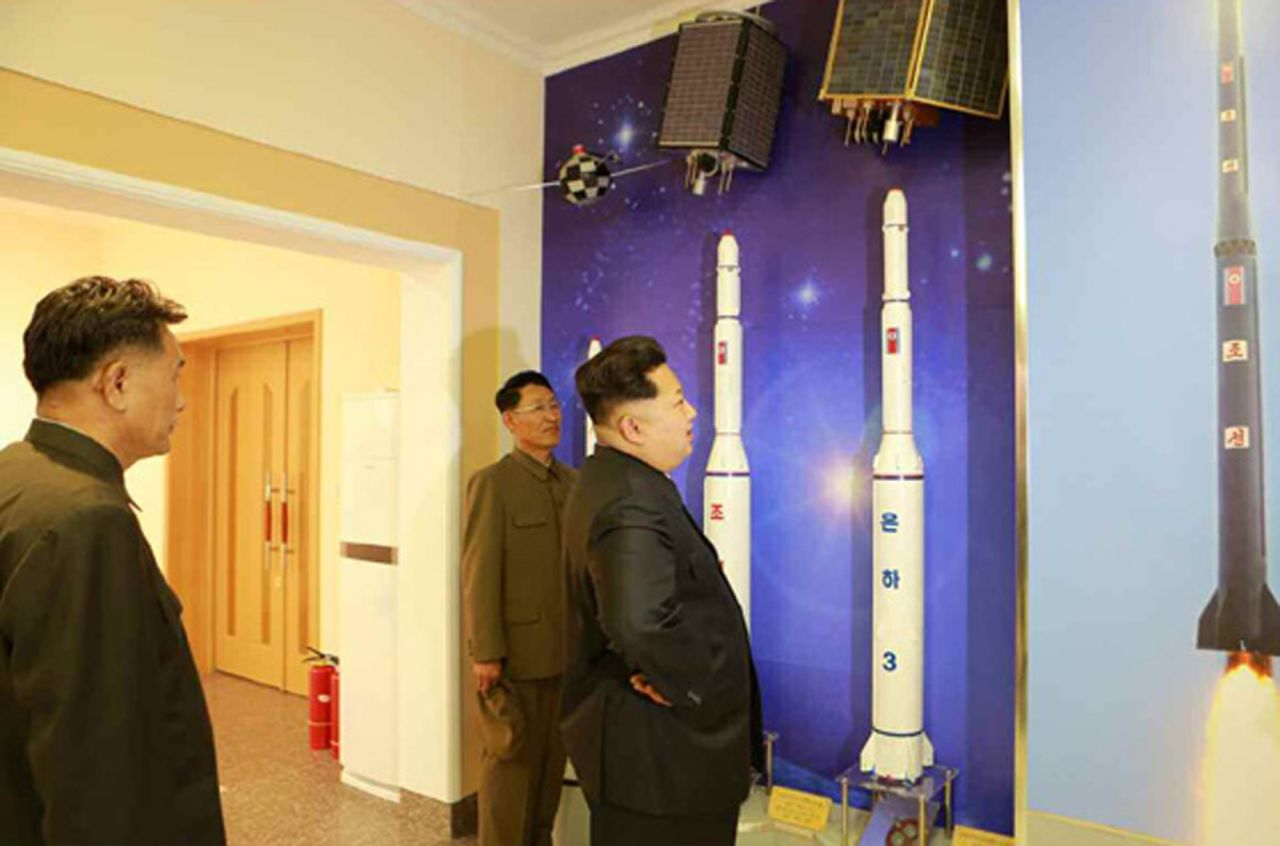 Kim Jong Un inspects models and illustrations of rockets inside the satellite control center.