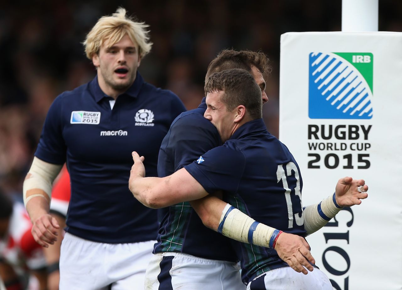 Scotland players celebrate Bennett's first try at the Kingsholm Stadium.
