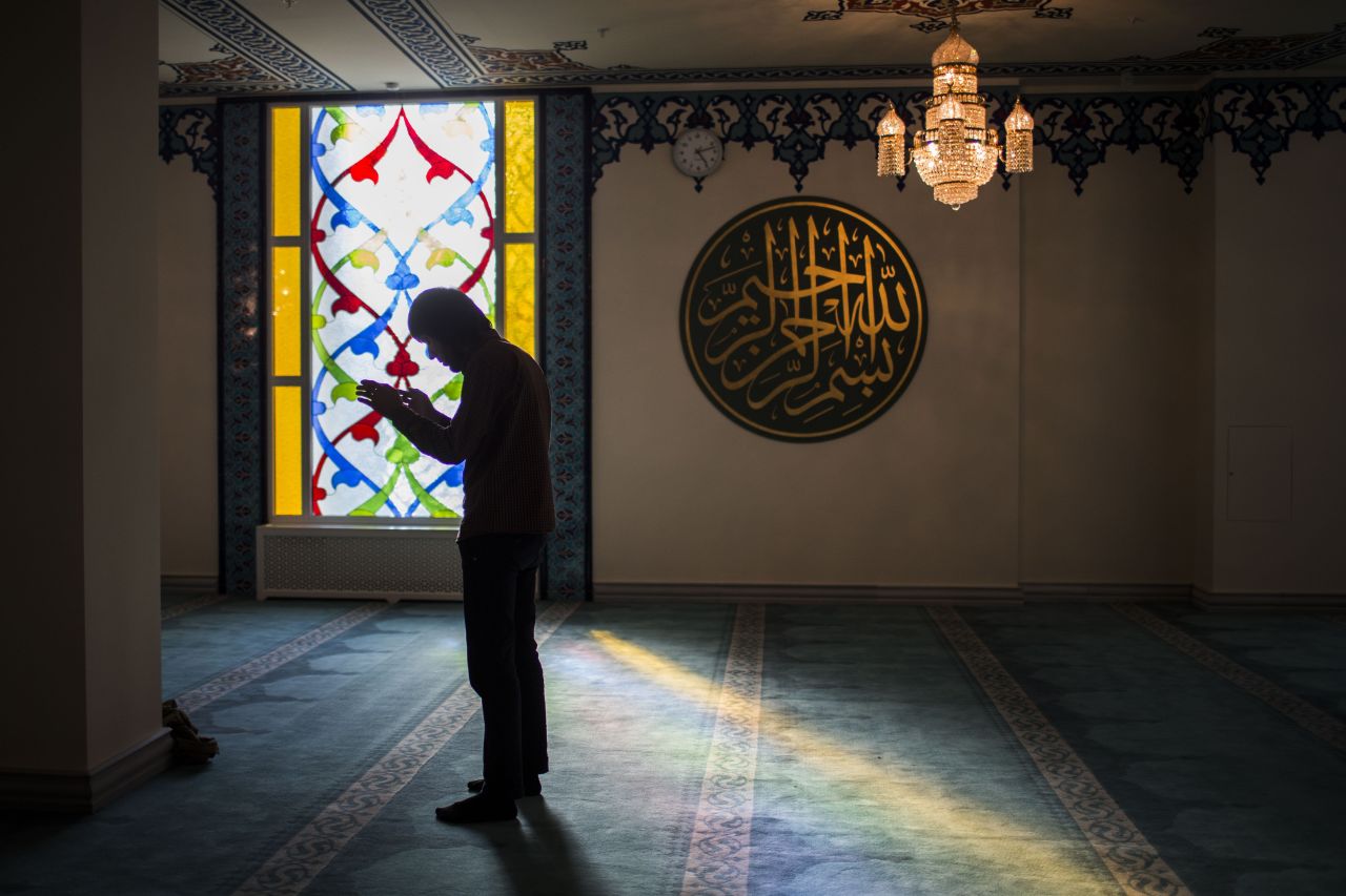A Muslim prays in the mosque on the evening of its opening. 