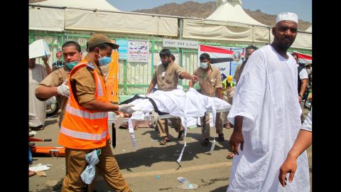 Saudi emergency personnel carry a body.
