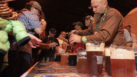 Tim Hawn, brewmaster for Dogfish Head brewery, pours beers at the 2013 Great American Beer Festival.