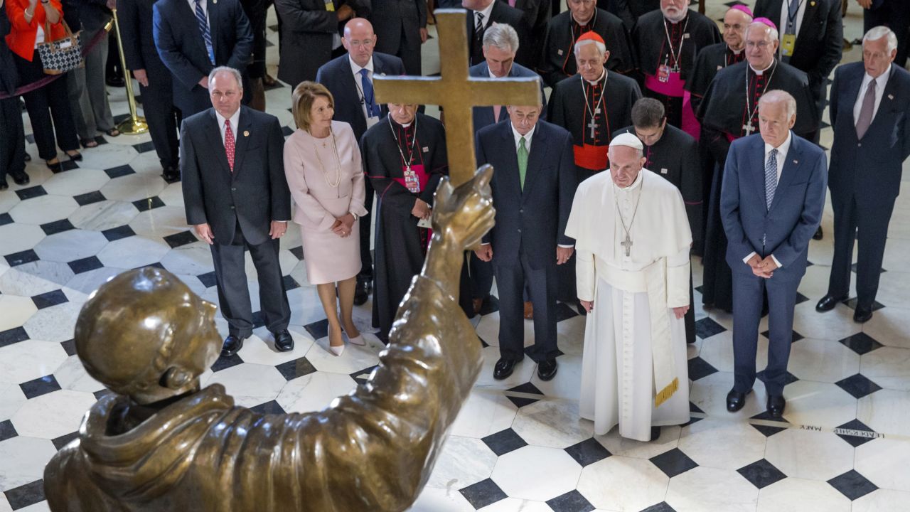Pope Francis stops to look at a sculpture of Spanish-born missionary Junipero Serra at the U.S. Capitol in Washington on September 24. The Pope canonized Serra during a Mass the day before.